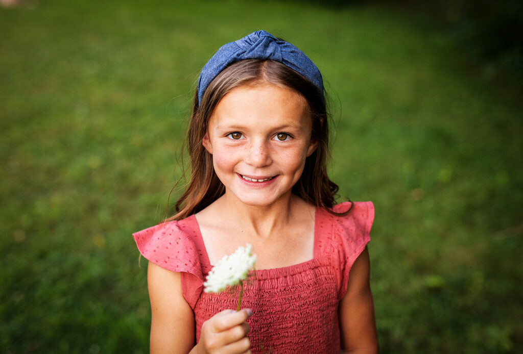 Little girl holding a flower at a family photoshoot