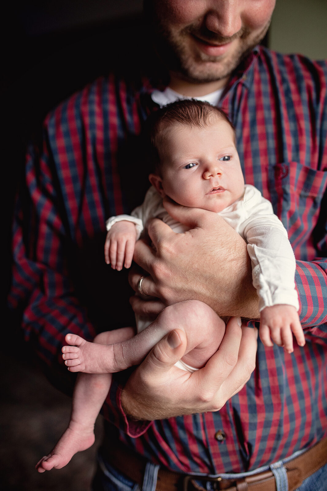Close up of baby girl in dads hands