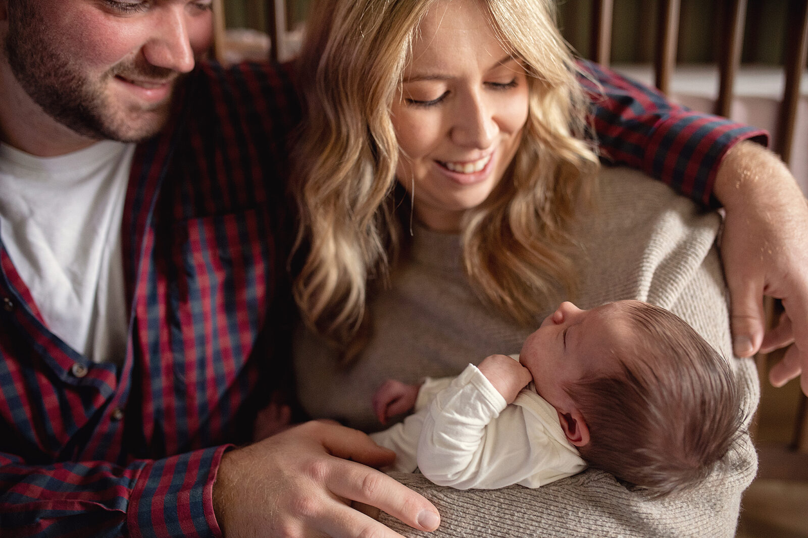 In-home newborn session in columbus ohio, mom and dad holding newborn baby