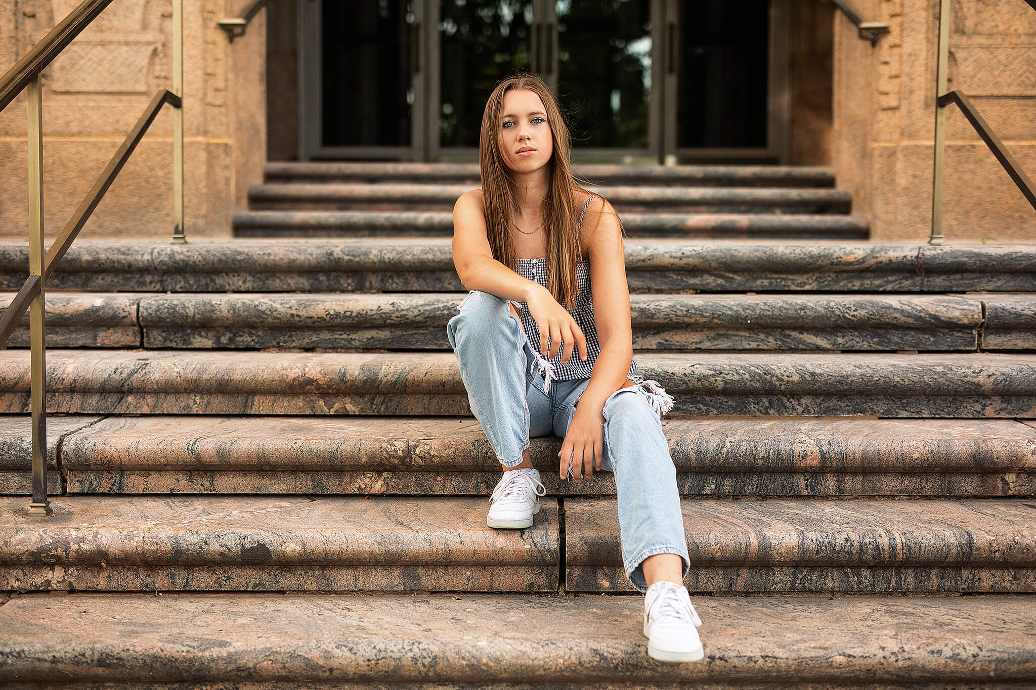Colonel Crawford High school senior girl sitting on steps of building