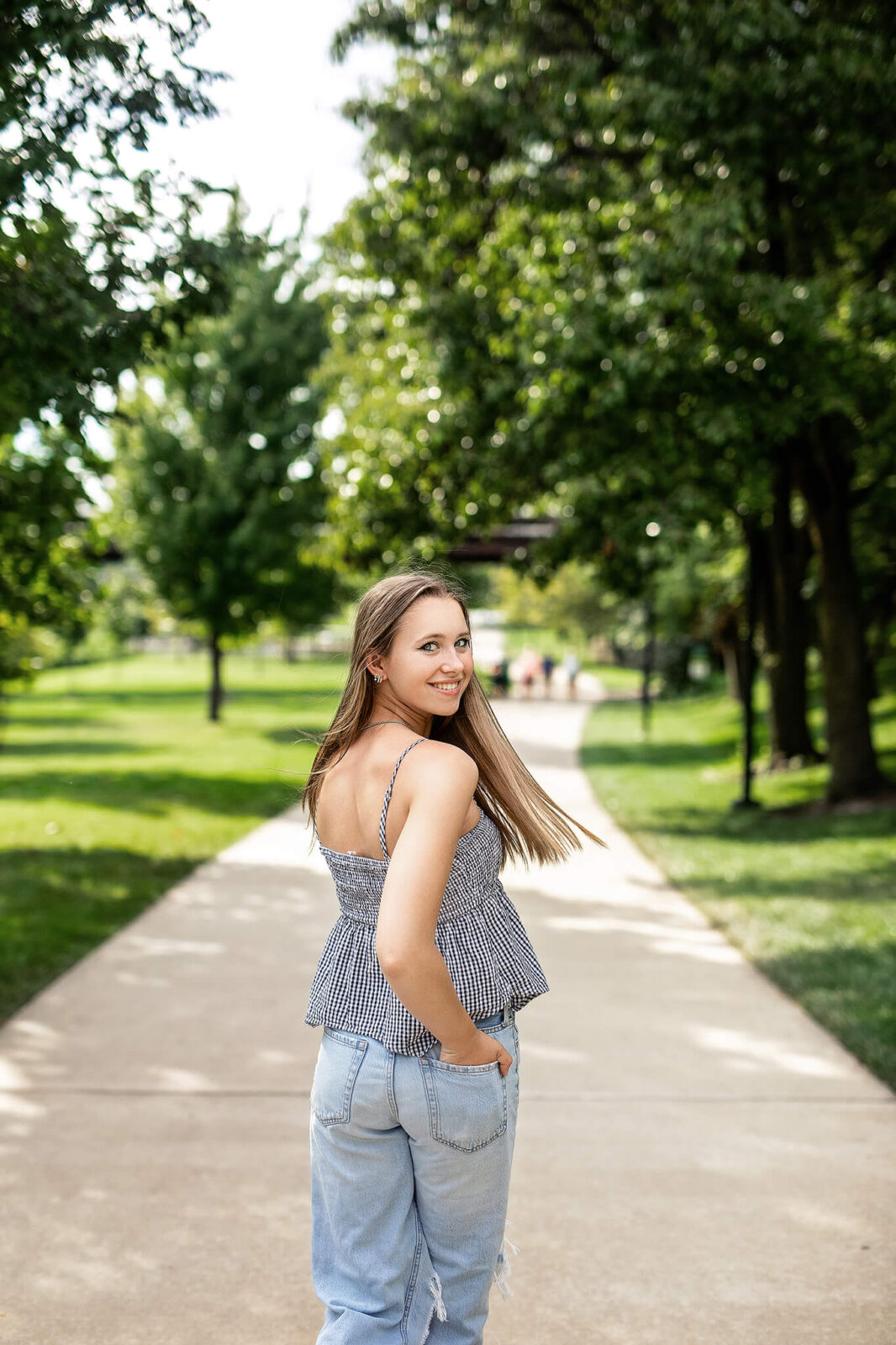 High school senior girl walking down path at Scioto Mile in Downtown columbus ohio