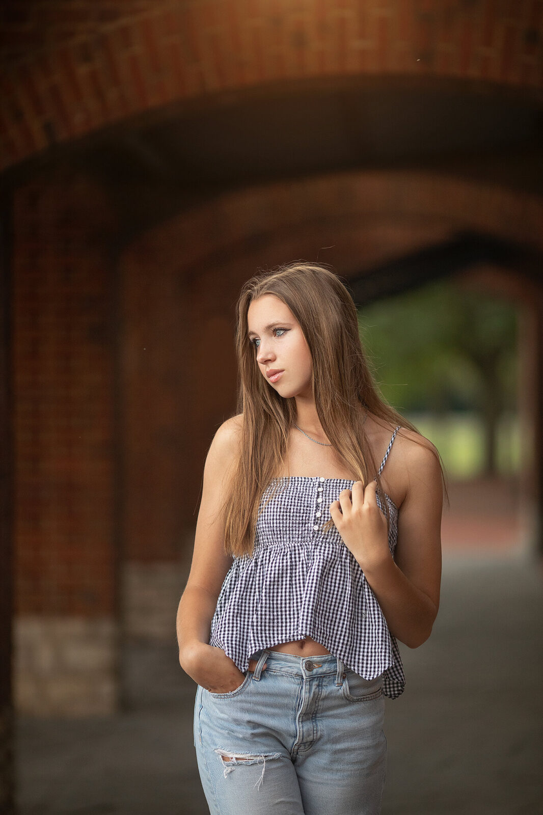 High school senior sanding in arch way at Scioto Mile