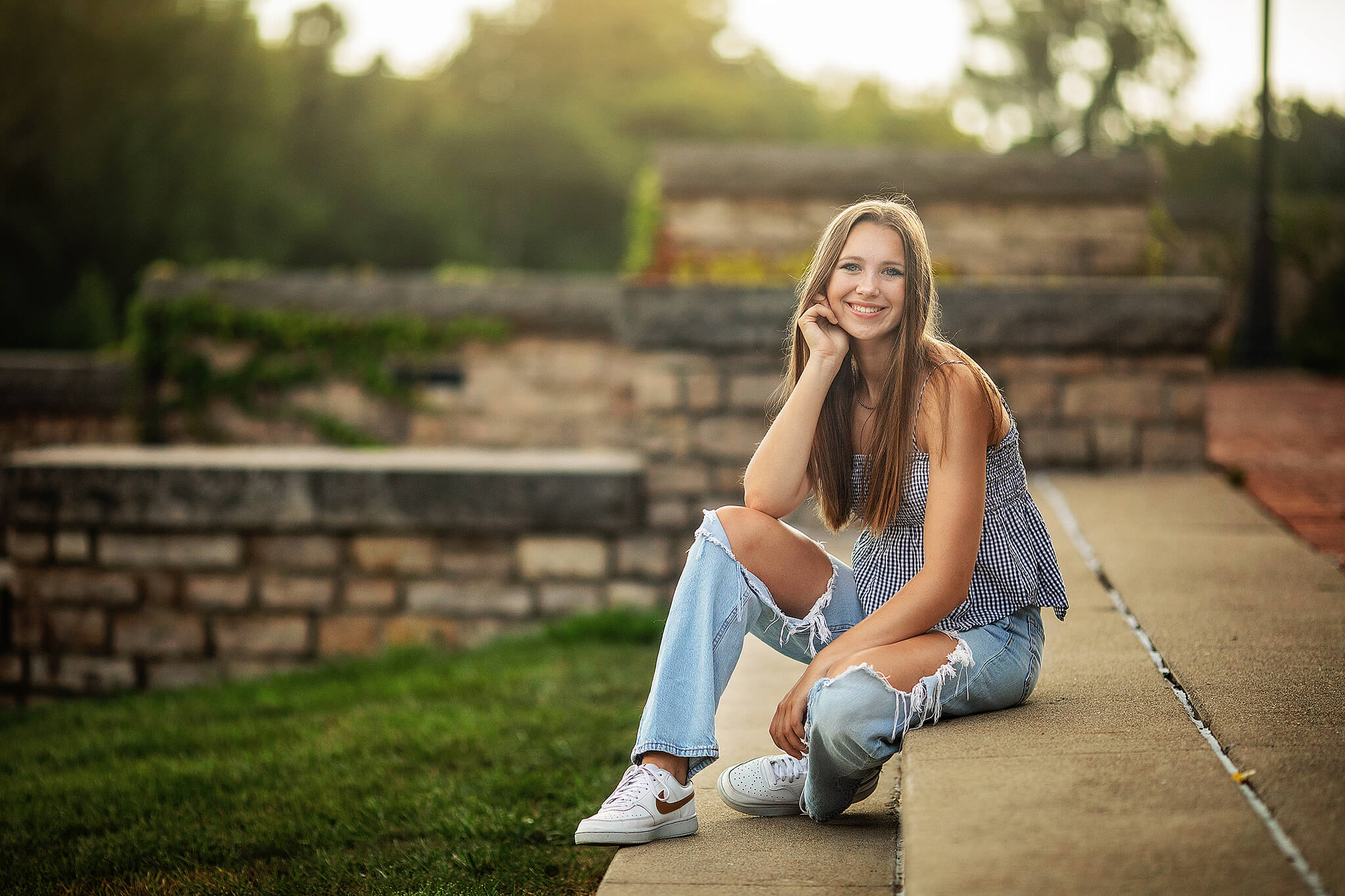 Colonel Crawford High school senior sitting on steps in a green area at scioto mile in columbus ohio