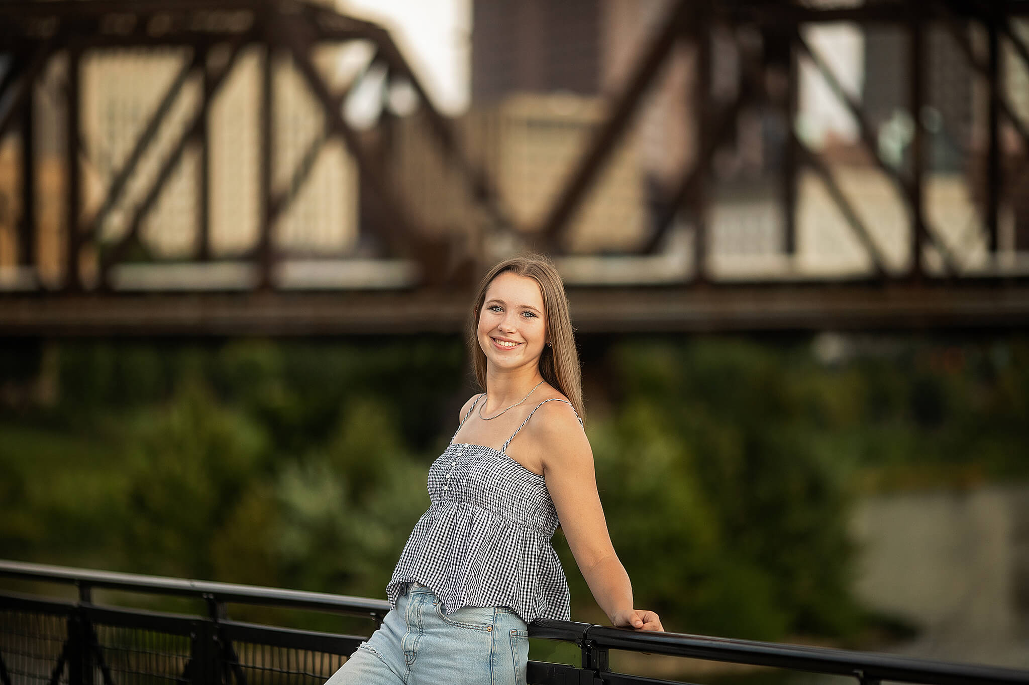 high school girl standing in front of large grain bridge at scioto mile