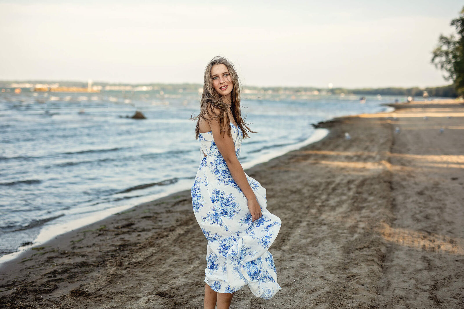 High school senior dancing on beach at east harbor state park ohio