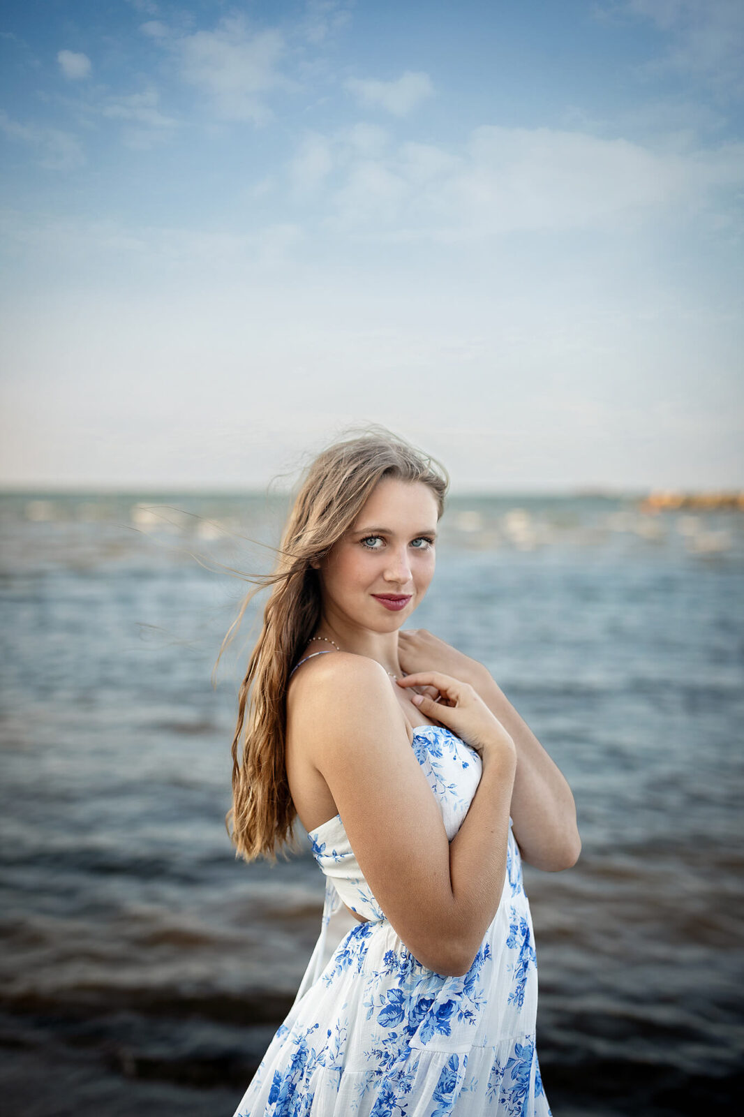 colonel crawford high school senior getting photos taken at east harbor state park in front of the water