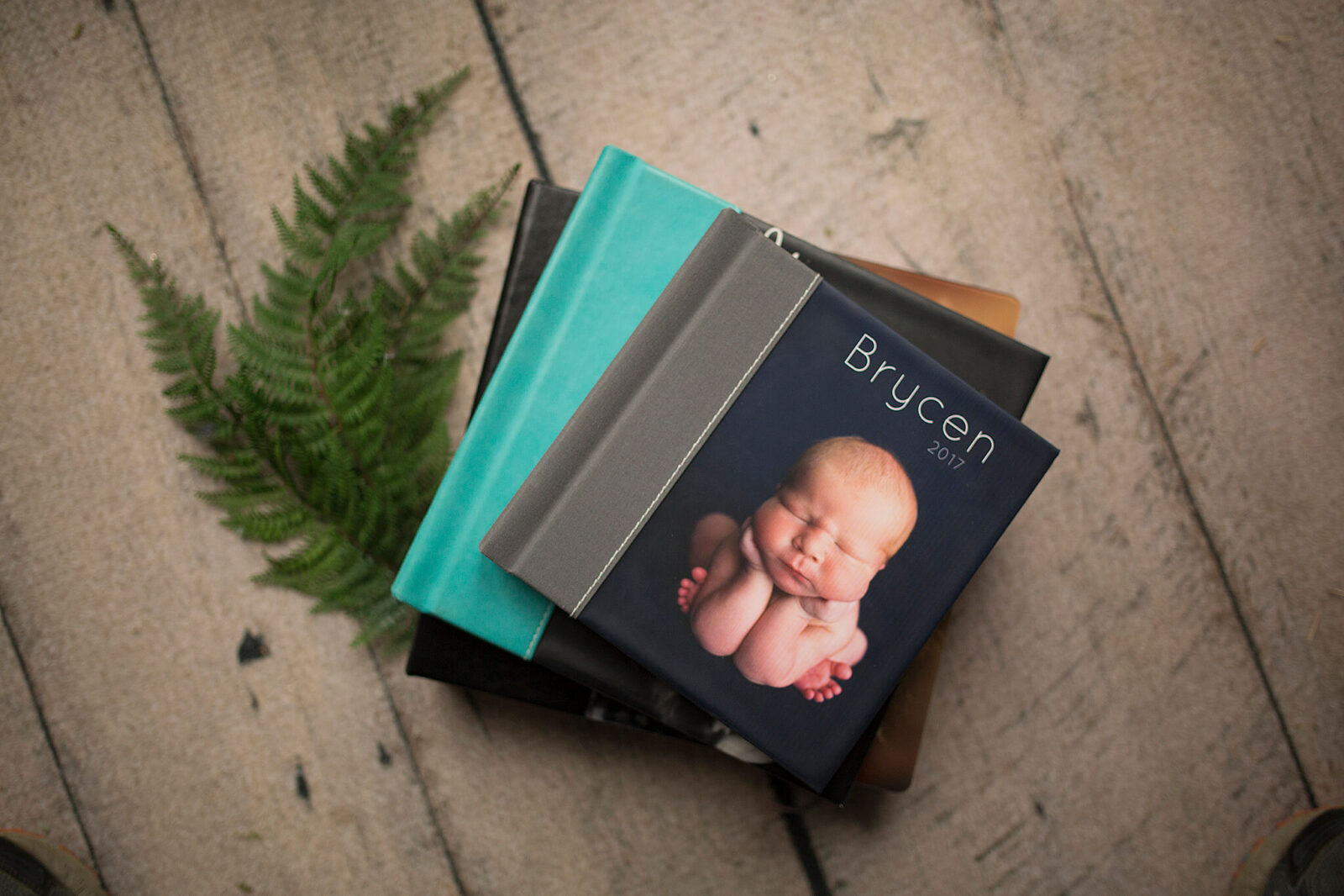 Creative-ways-to-display-photos-at home. 3 albums stacked on top of each other